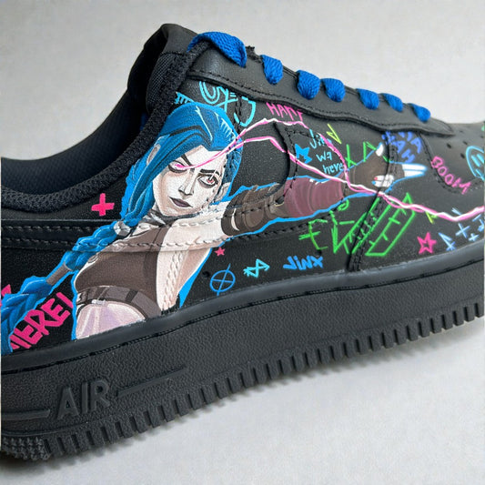 Jinx-inspired custom Nike Air Force 1 sneaker with hand-painted blue-haired character art and neon graffiti details on a black leather base.