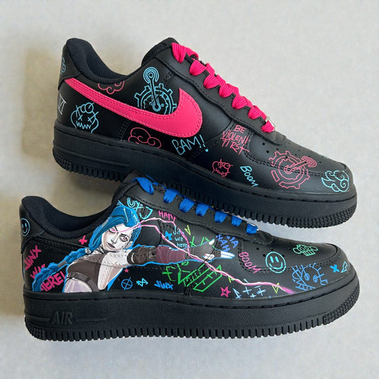 Custom Nike Air Force 1 sneakers inspired by Jinx from Arcane, featuring hand-painted character art, neon graffiti details, and mismatched pink and blue laces on a black leather base.