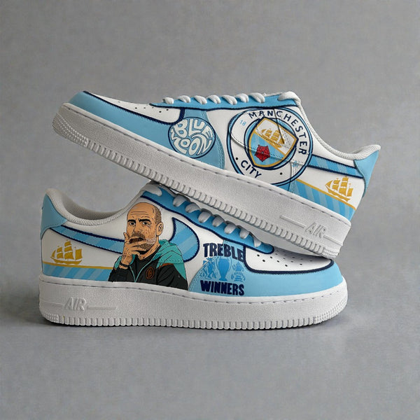 Custom Nike Air Force 1 sneakers inspired by Manchester City, featuring sky-blue and white panels, hand-painted Pep Guardiola portrait, club crest, and Treble Winners artwork.