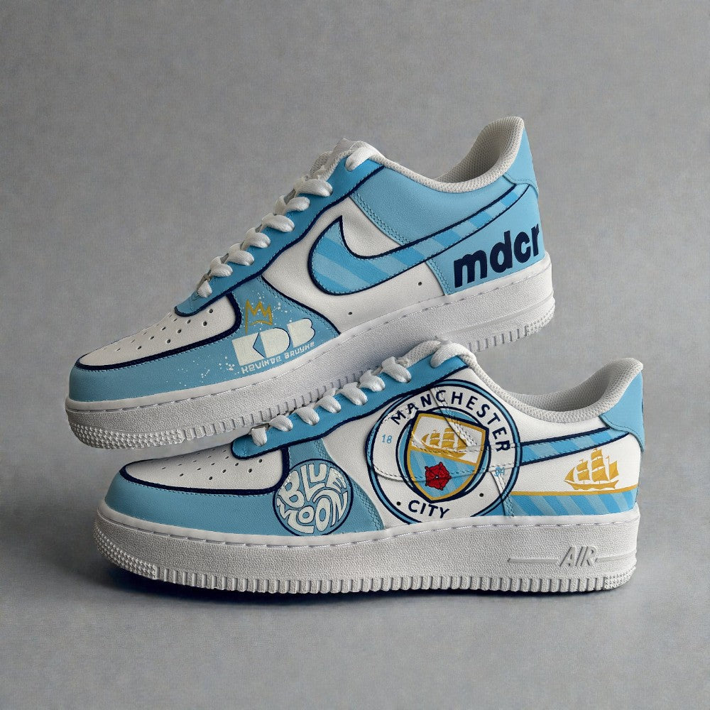 Custom Manchester City Nike Air Force 1 sneakers in sky blue and white, featuring hand-painted club crest, Blue Moon detailing, and MDCI typography.