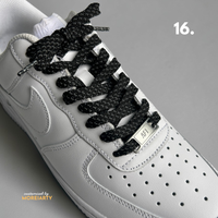 Reflective laces under flash showing silver glow effect on sneaker