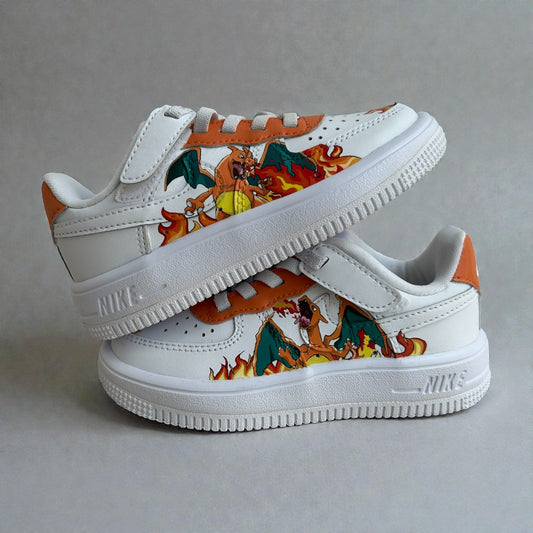 Custom hand-painted Nike Air Force 1 kids sneakers featuring a fire-breathing dragon illustration inspired by anime, with orange detailing, layered flames, and precise brushwork on premium white leather.