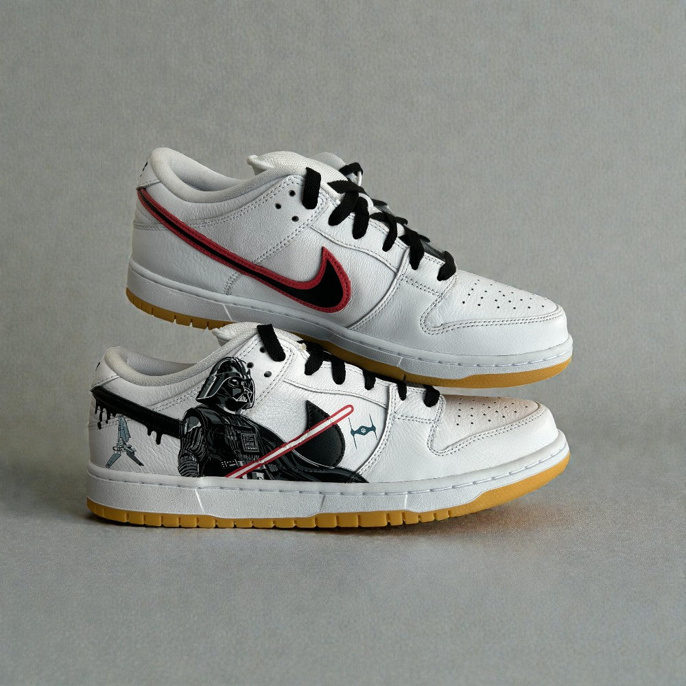 Custom Nike Dunk Low Star Wars sneakers with hand-painted Darth Vader artwork, red lightsaber detail, black swoosh, and gum outsole.