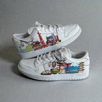 Custom hand-painted sneakers inspired by Japanese culture, travel, and cityscape illustrations on white leather.