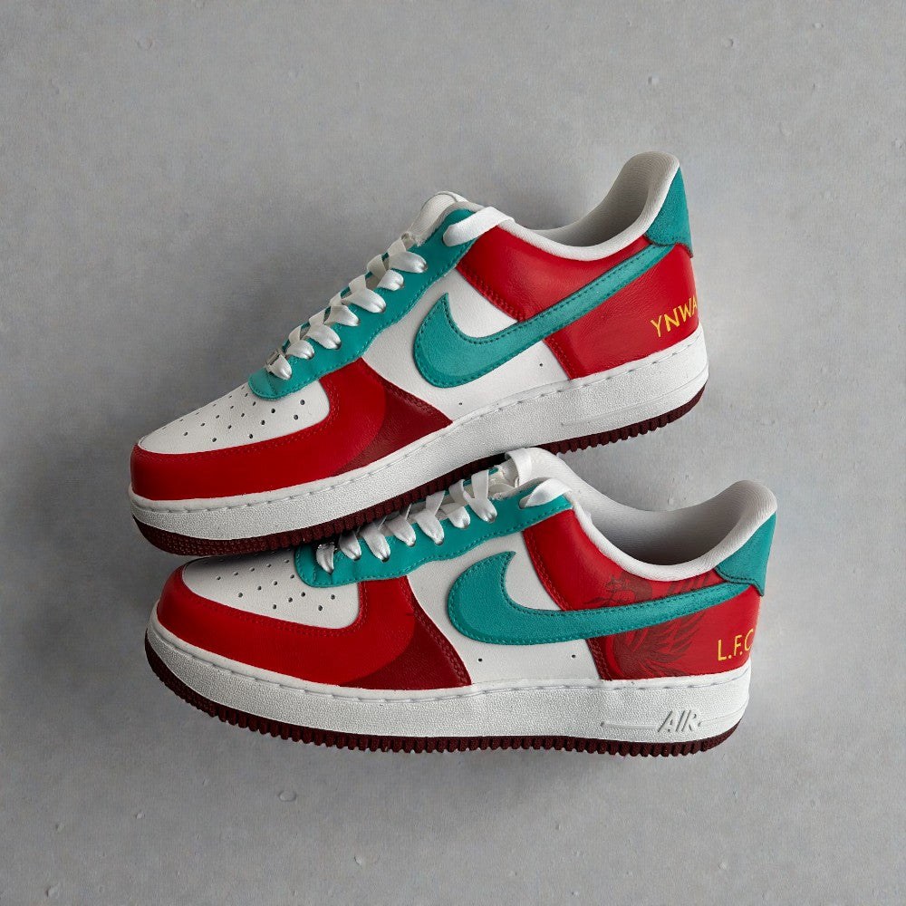 Custom Nike Air Force 1 sneakers in red, white, and teal with teal swoosh, white laces, and Liverpool FC–inspired detailing on the heel.