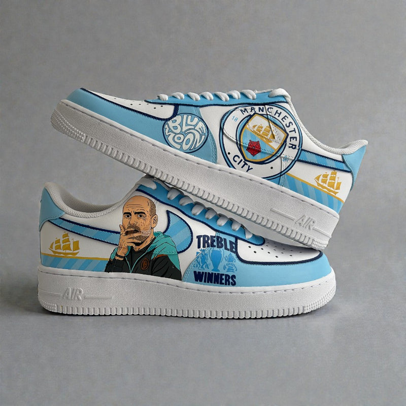 Custom Nike Air Force 1 sneakers inspired by Manchester City, featuring sky-blue and white panels, hand-painted Pep Guardiola portrait, club crest, and Treble Winners artwork.