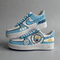 Custom Manchester City Nike Air Force 1 sneakers in sky blue and white, featuring hand-painted club crest, Blue Moon detailing, and MDCI typography.
