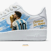 Moreiarty custom Nike Air Force 1 — Messi Campeon del Mundo, hand-painted Qatar 2022 World Cup kiss moment in sky blue and gold on white leather