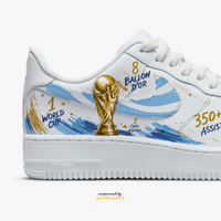 Close-up of Moreiarty custom AF1 inside panel — hand-painted World Cup trophy with Messi career stats, 1 World Cup, 8 Ballon d'Or, 350+ assists lettering