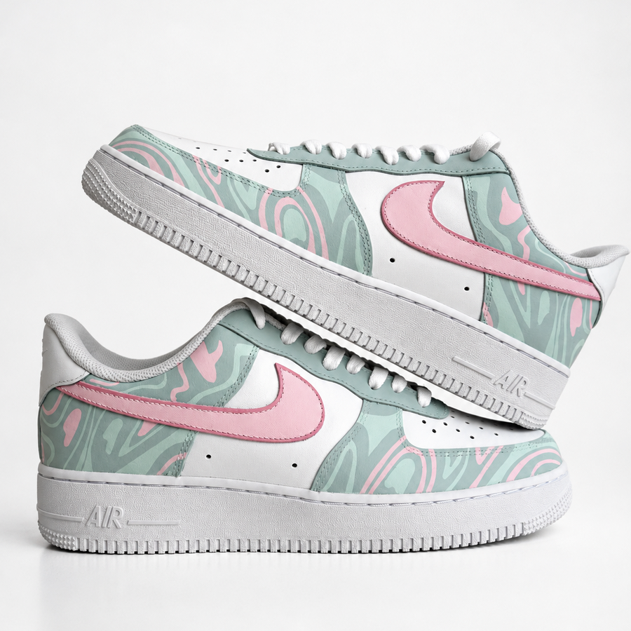 A pair of Nike Air Force 1 Low handpainted custom sneakers featuring a pastel mint green and pink marble pattern on the overlays, white leather panels, and white midsoles with gray detailing.