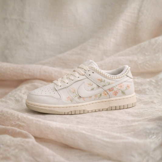 White sneaker with floral pattern on a beige fabric background