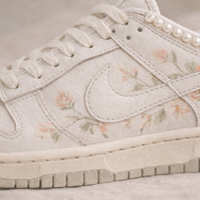 White sneaker with floral pattern on a light background