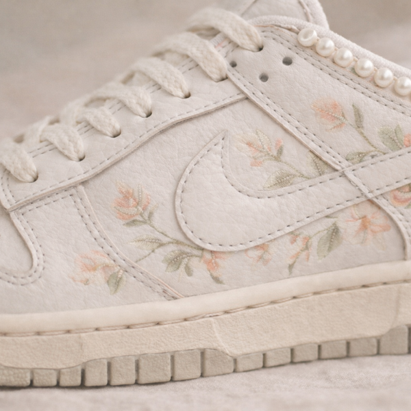 White sneaker with floral pattern on a light background