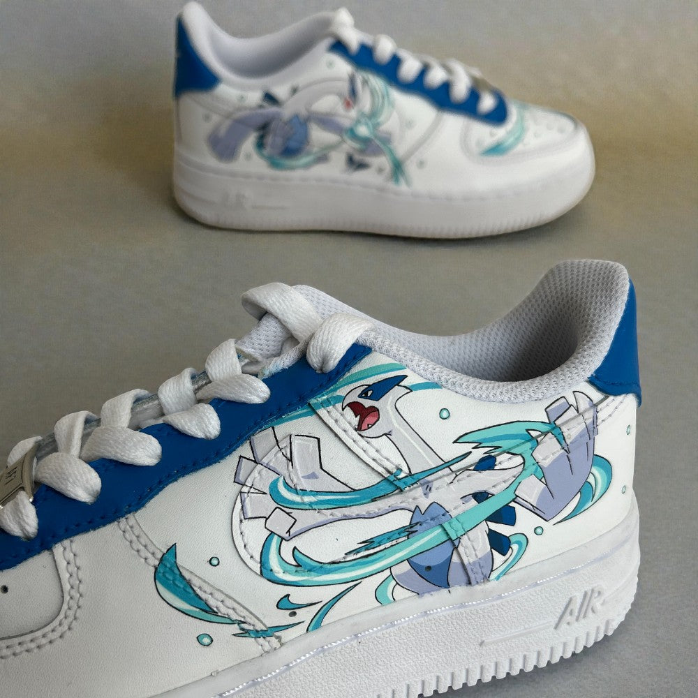 Close-up side detail of custom hand-painted Nike Air Force 1 sneakers featuring anime-inspired blue and white character artwork with dynamic motion effects, painted on a premium white leather base with blue lace panel accents.