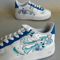 Close-up side detail of custom hand-painted Nike Air Force 1 sneakers featuring anime-inspired blue and white character artwork with dynamic motion effects, painted on a premium white leather base with blue lace panel accents.
