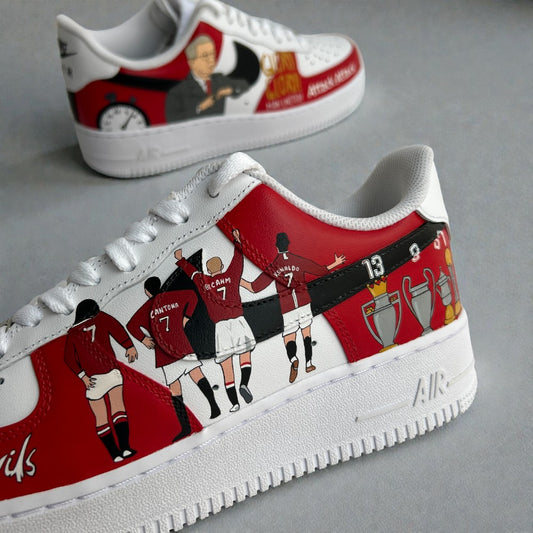 Custom hand-painted Nike Air Force 1 sneakers inspired by Manchester United, featuring illustrated silhouettes of club legends including Cantona, Beckham, Ronaldo, and trophy motifs, painted by hand on premium white leather with classic red accents.